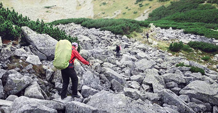 man hiking on rocky terrain