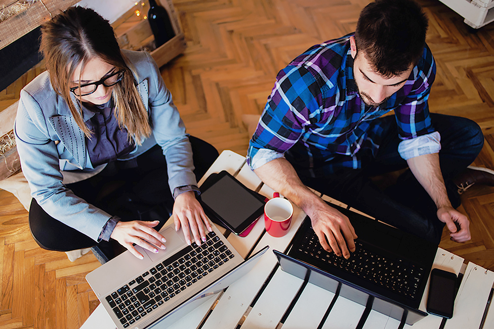 couple working on their laptops
