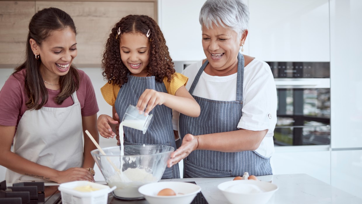 Three Latina generations baking together in a kitchen