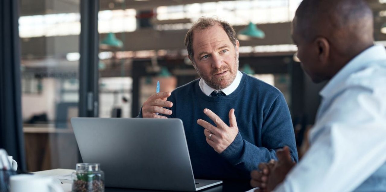 Middle-aged financial professional meeting with new client