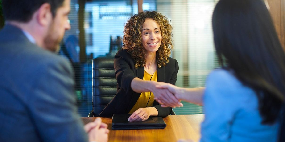 Female financial services professional meeting with couple