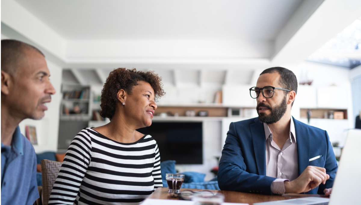 Middle-aged couple at home meeting with financial professional
