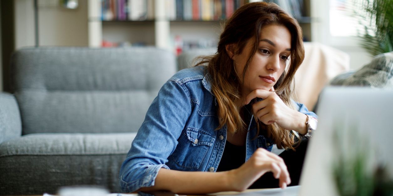 Young adult woman at home on her laptop