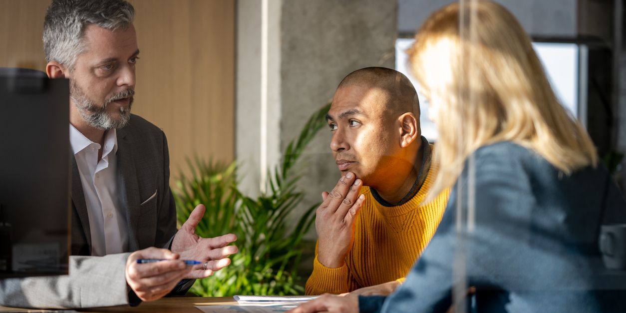 Financial professional meets with his clients in an office