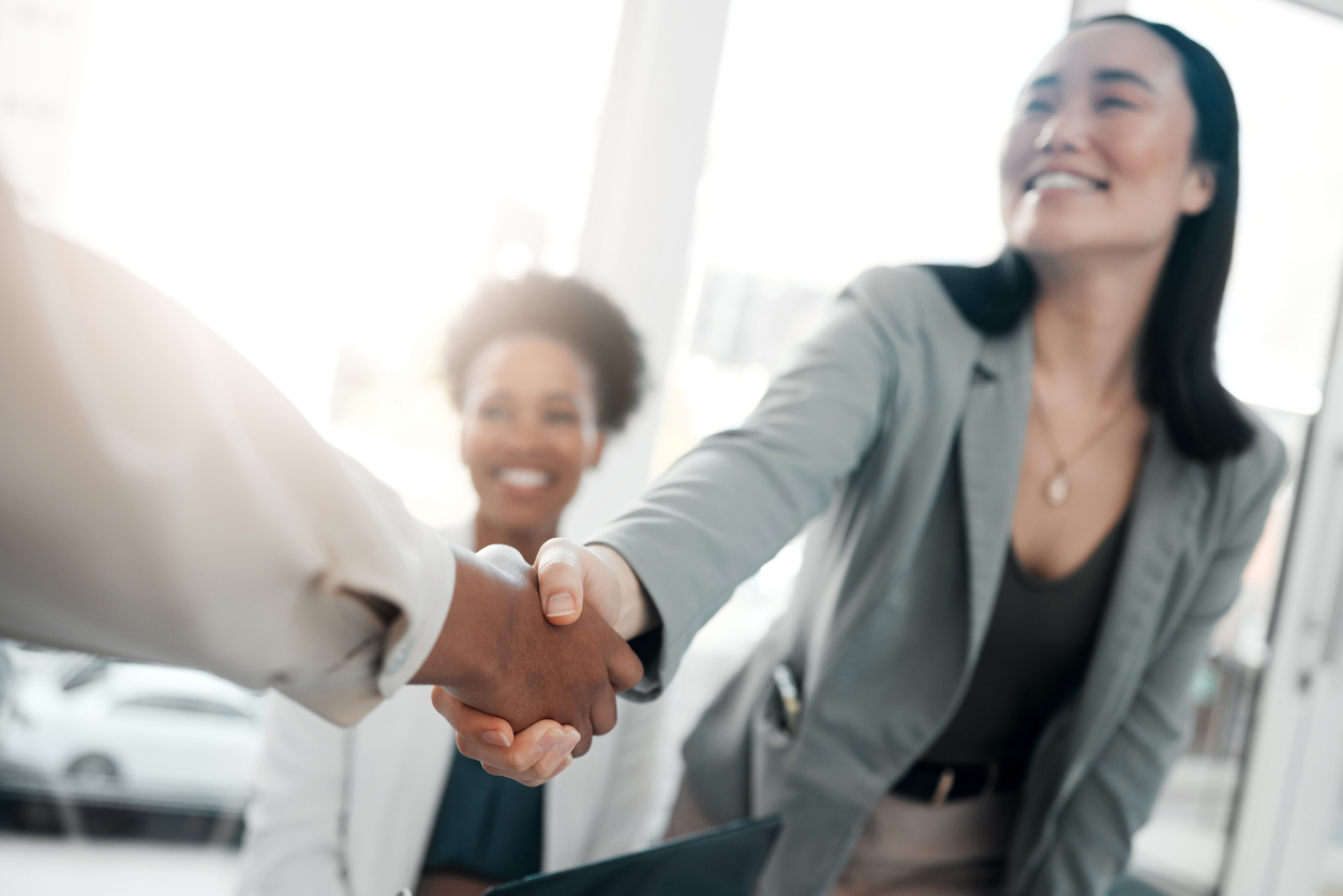 Asian woman welcoming new employee to the office