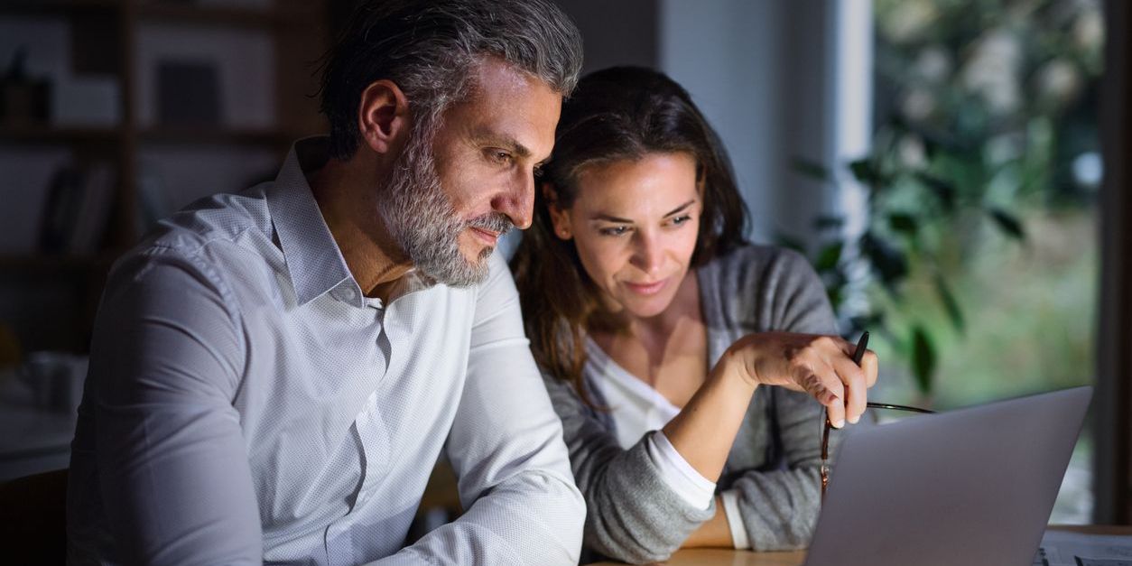 Middle-aged couple at home planning for their required minimum distributions